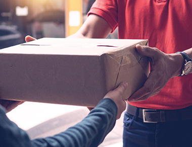 a persona handing a parcel to a person